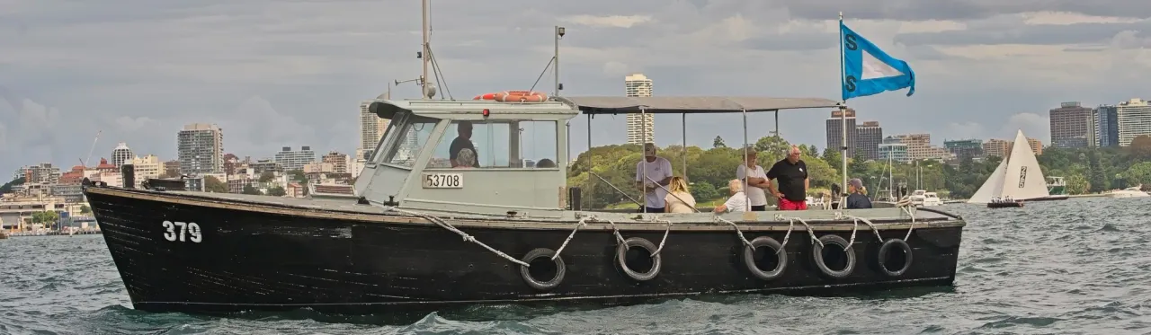 The club's spectator ferry flying the Squadron burgee, with No. 225 racing beyond